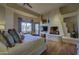 Comfortable main bedroom features a fireplace and seating area with access to outdoor patio at 7373 E Clubhouse Dr # 24, Scottsdale, AZ 85266