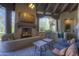 Inviting outdoor living space complete with fireplace, grill, and comfortable seating at 7373 E Clubhouse Dr # 24, Scottsdale, AZ 85266