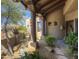 Front porch featuring desert landscaping, wood columns, and a walkway leading up to an earth tone colored home at 7373 E Clubhouse Dr # 24, Scottsdale, AZ 85266