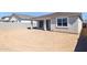 Unlandscaped backyard featuring dirt, a covered patio, and block wall at 7422 W Buckhorn Trl, Peoria, AZ 85383