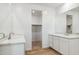 This bathroom features double sinks, white cabinetry and modern fixtures at 7422 W Buckhorn Trl, Peoria, AZ 85383
