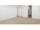 Bright bedroom features neutral carpet, a door and an ensuite bathroom at 7422 W Buckhorn Trl, Peoria, AZ 85383