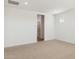 A bright, carpeted bedroom with an ensuite bathroom, offering a serene and private space at 7422 W Buckhorn Trl, Peoria, AZ 85383