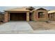 New home under construction, showcasing the framing and concrete driveway in a developing neighborhood at 7422 W Buckhorn Trl, Peoria, AZ 85383