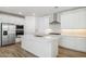 Bright kitchen showcasing a central island, stainless steel appliances, and pristine white cabinetry at 7422 W Buckhorn Trl, Peoria, AZ 85383