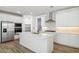Bright, modern kitchen with white cabinetry, stainless steel appliances, and an expansive island at 7422 W Buckhorn Trl, Peoria, AZ 85383
