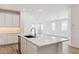 Open concept kitchen with a large island, modern appliances, and seamless flow into the living area at 7422 W Buckhorn Trl, Peoria, AZ 85383