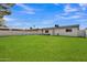 Large grassy backyard, perfect for entertaining or relaxing, with a white privacy wall at 7526 E Drummer Ave, Mesa, AZ 85208
