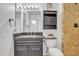 Charming bathroom features stone shower, granite counter top, wood cabinets and decorative details at 7526 E Drummer Ave, Mesa, AZ 85208