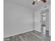 Bright, airy bedroom with new gray luxury vinyl flooring shows open door and ceiling fan at 7526 E Drummer Ave, Mesa, AZ 85208