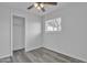 This light, bright bedroom has gray luxury vinyl flooring and a spacious closet at 7526 E Drummer Ave, Mesa, AZ 85208