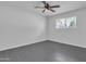 Bright bedroom features neutral walls, a ceiling fan, and a window letting in natural light at 7526 E Drummer Ave, Mesa, AZ 85208