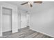 Light and bright bedroom with gray luxury vinyl flooring, ceiling fan and open closet at 7526 E Drummer Ave, Mesa, AZ 85208