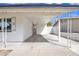 Attached carport offering covered parking with white painted beams and brick wall at 7526 E Drummer Ave, Mesa, AZ 85208