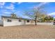 Inviting single-story home with a fresh white exterior and minimalist rock landscaping at 7526 E Drummer Ave, Mesa, AZ 85208
