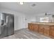 Updated kitchen features stainless steel refrigerator and wood cabinetry with granite countertops at 7526 E Drummer Ave, Mesa, AZ 85208