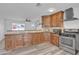 Updated kitchen featuring granite countertops, stainless steel appliances, and wood cabinets at 7526 E Drummer Ave, Mesa, AZ 85208