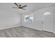 Bright living room features new gray luxury vinyl flooring, white walls and ceiling fan at 7526 E Drummer Ave, Mesa, AZ 85208