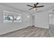 Bright and airy living room features new gray luxury vinyl flooring and ceiling fan at 7526 E Drummer Ave, Mesa, AZ 85208