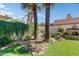 Beautiful backyard featuring an outdoor kitchen, decorative rock, lush lawn, and mature trees at 7725 N Via De Fonda --, Scottsdale, AZ 85258