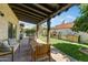 Charming backyard with a covered patio, outdoor kitchen, manicured lawn, and mature trees at 7725 N Via De Fonda --, Scottsdale, AZ 85258