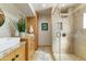 Modern bathroom with a glass shower, dual sinks, wood cabinets, and stylish decor at 7725 N Via De Fonda --, Scottsdale, AZ 85258