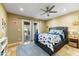 This bedroom features a ceiling fan, sliding glass doors, and a plush blue area rug at 7725 N Via De Fonda --, Scottsdale, AZ 85258