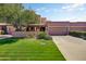 Charming single-story home with lush lawn, mature tree, and two-car garage in daylight at 7725 N Via De Fonda --, Scottsdale, AZ 85258