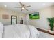 Bright main bedroom with a ceiling fan, mounted TV, and easy access to the home office at 7725 N Via De Fonda --, Scottsdale, AZ 85258