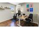 Bright home office featuring a modern desk, exercise bike, stylish decor, and hardwood floors at 7725 N Via De Fonda --, Scottsdale, AZ 85258