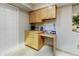 An office nook features wooden cabinets above and below, drawers, workspace, and neutral colors at 7725 N Via De Fonda --, Scottsdale, AZ 85258