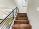 A modern staircase with hardwood steps and a black metal railing at 7725 N Via De Fonda --, Scottsdale, AZ 85258