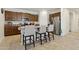 Kitchen island with granite countertop, three bar stools, and stainless steel appliances at 786 W Palo Verde W Dr, Casa Grande, AZ 85122