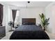 Well-lit bedroom features a large bed, minimalist decor, and a ceiling fan at 786 W Palo Verde W Dr, Casa Grande, AZ 85122
