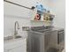 Functional laundry room with modern washer and dryer, sink, and ample storage space at 786 W Palo Verde W Dr, Casa Grande, AZ 85122