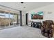 Bright living room featuring large glass doors, neutral walls, and plush carpeting at 786 W Palo Verde W Dr, Casa Grande, AZ 85122