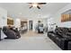 Open-concept living room with seating, kitchen access, and bright natural light at 786 W Palo Verde W Dr, Casa Grande, AZ 85122
