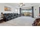 Spacious living room with plush carpeting, a ceiling fan, and sliding glass doors to the patio at 786 W Palo Verde W Dr, Casa Grande, AZ 85122