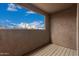 An outdoor balcony with a view of palm trees and a bright blue sky at 8155 E Roosevelt St # 204, Scottsdale, AZ 85257
