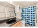 Standard bathroom with a shower/tub, cabinet storage and a framed mirror with vanity lighting at 8155 E Roosevelt St # 204, Scottsdale, AZ 85257