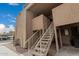 Apartment building with desert landscaping, and stairs leading to an upper-level unit at 8155 E Roosevelt St # 204, Scottsdale, AZ 85257