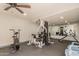 Gym features various weight training and cardio equipment with neutral walls and ceiling fan at 8155 E Roosevelt St # 204, Scottsdale, AZ 85257