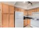 A bright kitchen with stainless steel appliances and wooden cabinets at 8155 E Roosevelt St # 204, Scottsdale, AZ 85257
