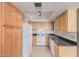Traditional eat-in kitchen features neutral cabinets, appliances and countertop with recessed lighting at 8155 E Roosevelt St # 204, Scottsdale, AZ 85257