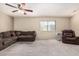 A spacious living room featuring a large window and neutral color scheme at 8155 E Roosevelt St # 204, Scottsdale, AZ 85257