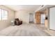 An open-concept living room and kitchen area with carpet and neutral paint at 8155 E Roosevelt St # 204, Scottsdale, AZ 85257