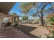 Expansive backyard features a covered patio, mature trees, and a tranquil hammock for relaxation at 8238 E San Miguel Ave, Scottsdale, AZ 85250