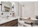 Elegant bathroom featuring a soaking tub, white marble walls, dark wood vanity, and modern fixtures at 8238 E San Miguel Ave, Scottsdale, AZ 85250