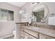 Bathroom with granite countertops, glass shelving, and a stylish, round mirror at 8238 E San Miguel Ave, Scottsdale, AZ 85250