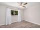 Bright, airy bedroom with hardwood flooring, a ceiling fan, and natural light through a window at 8238 E San Miguel Ave, Scottsdale, AZ 85250